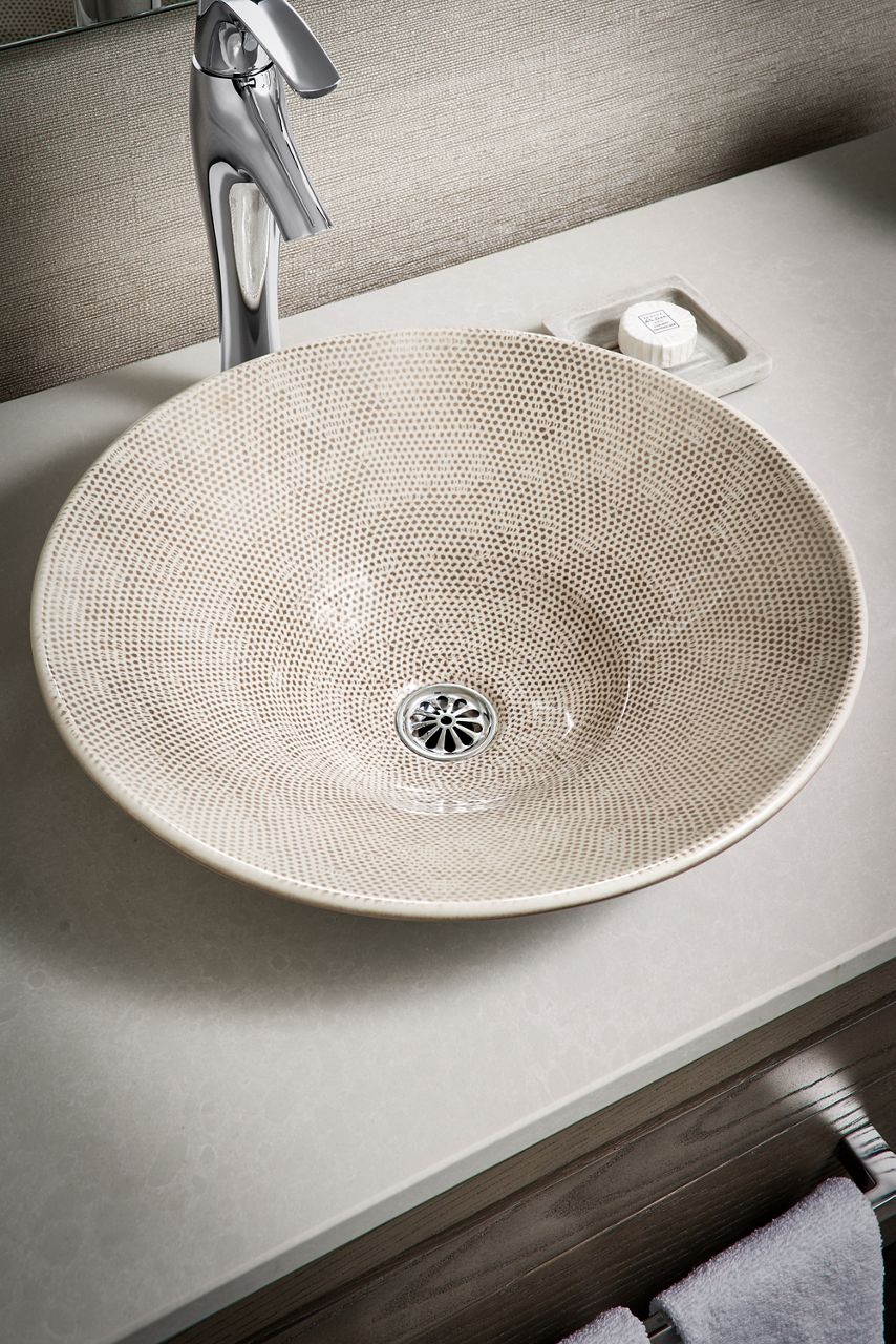 Aerial view of vessel sink paired with tall bathroom sink faucet.