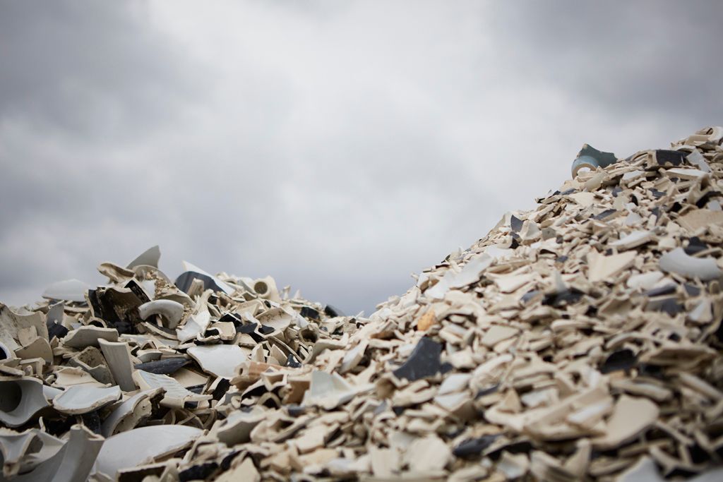 Large mound of light-colored recycled or repurposed materials.