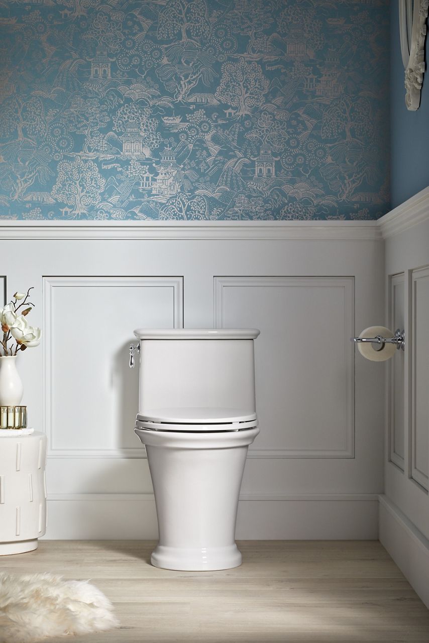 A traditional-styled toilet with fluted detailing at the base, the bowl, and the top of the tank.