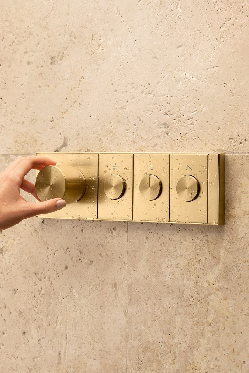 Thermostatic valve control in gold.