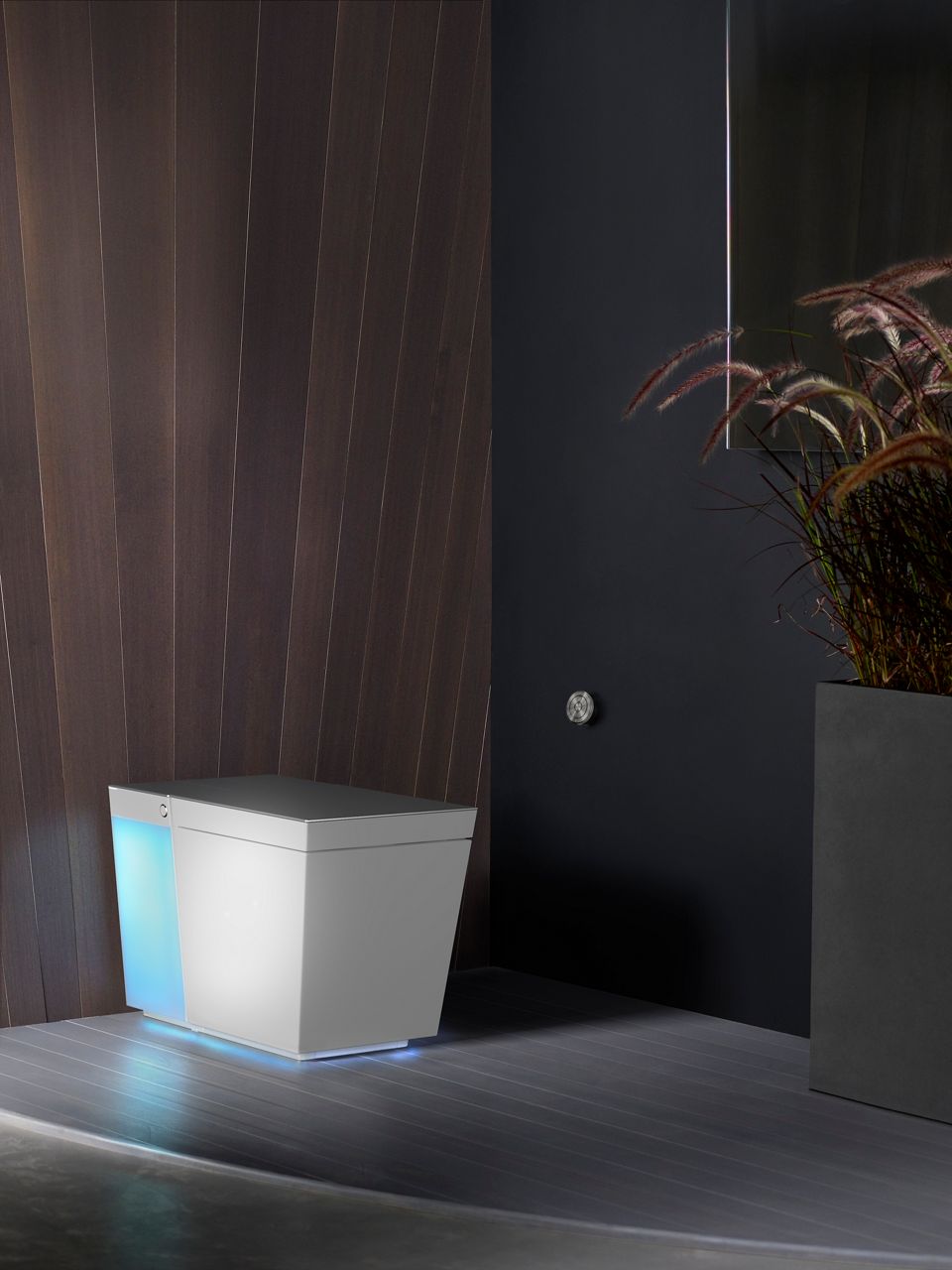 Touchless modern toilet with sleek design and soft blue light at base in dark bathroom.6