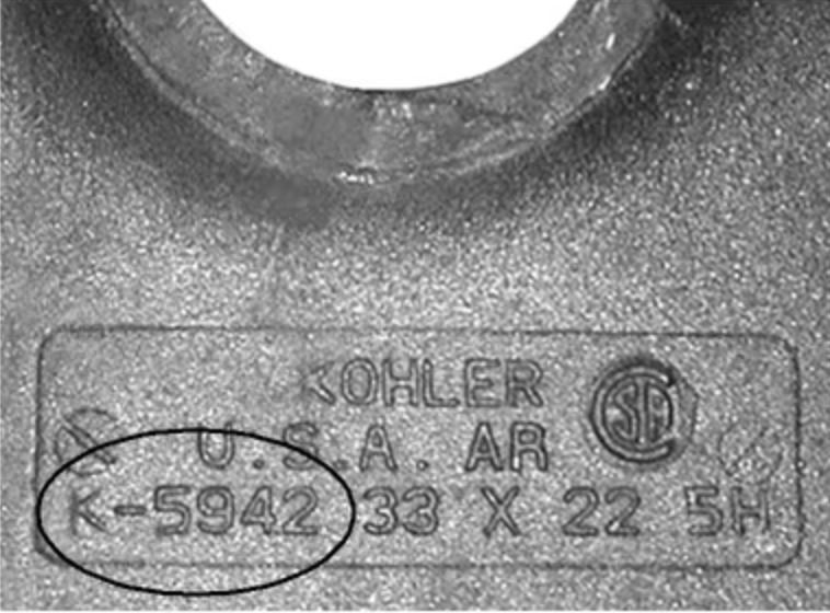 Close-up image of a product identification stamp on the underside of a Kohler product, focusing on the product number stamped into the material.