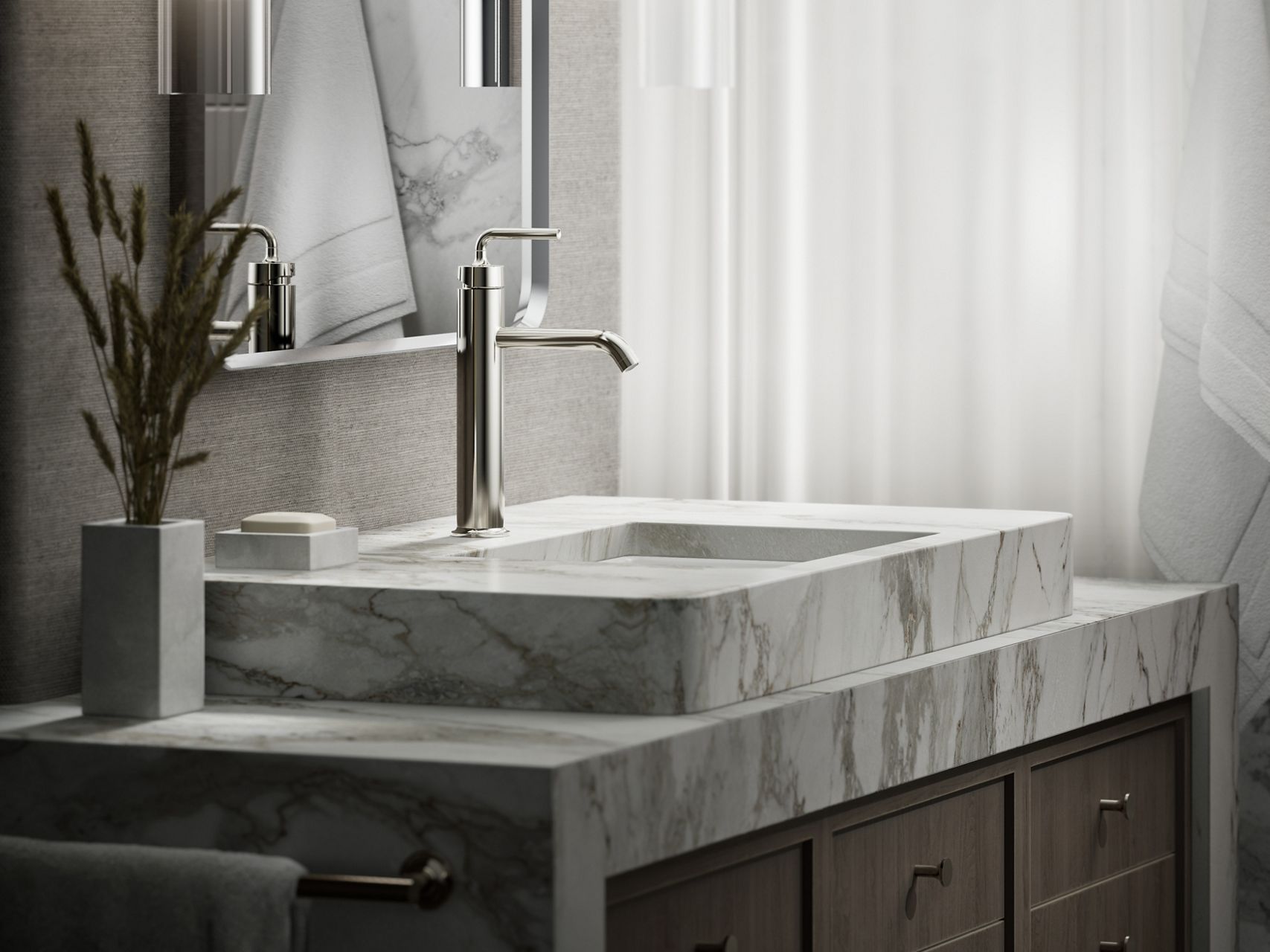 Contemporary silver faucet on a marble sink with running water.