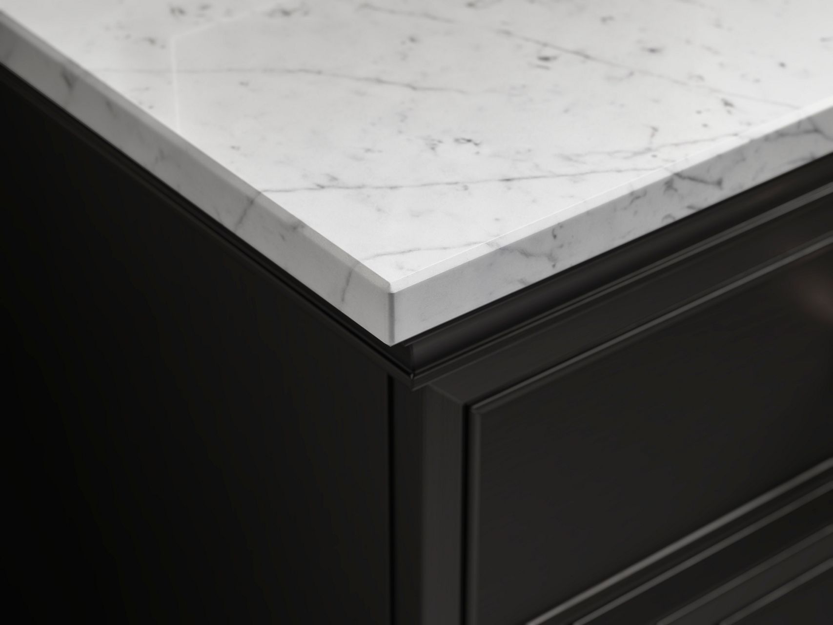 Close up of a white bathroom vanity, showing the waffle-patterned texture of the drawer, the black stone counter top with white veining, and the brass accents and faucet.