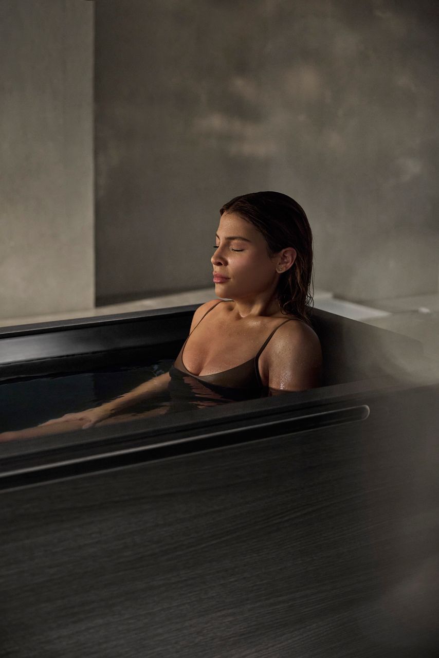 A woman sitting in a Kohler Ice Bath.