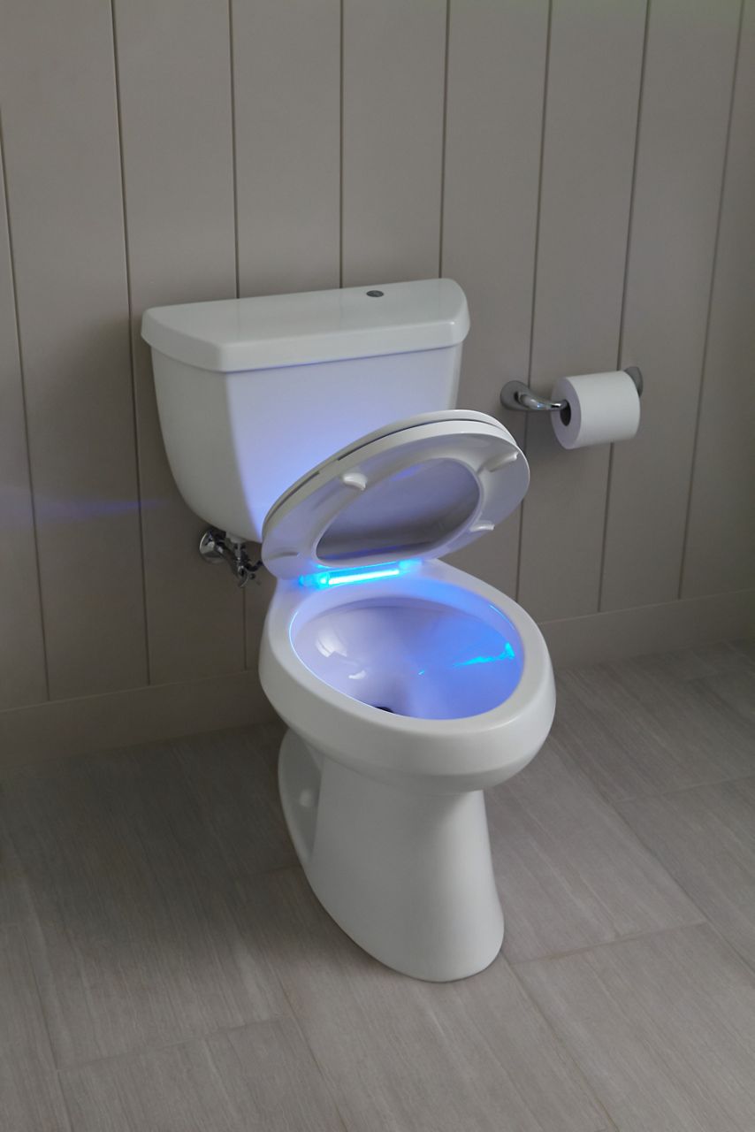 A white toilet with lid open to reveal a lighted toilet seat.