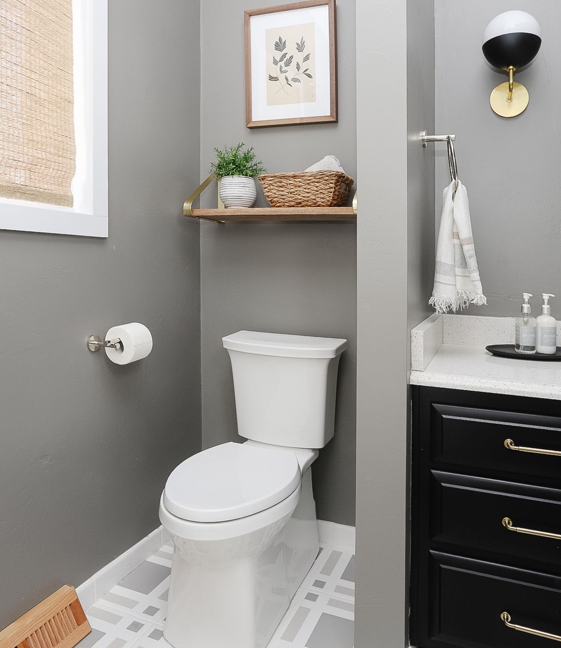 A KOHLER skirted toilet in a gray traditional bathroom