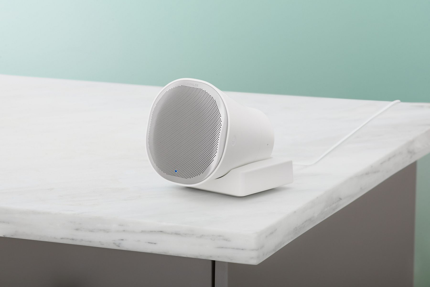 Wireless removable speaker from KOHLER Moxie showerhead on a shelf