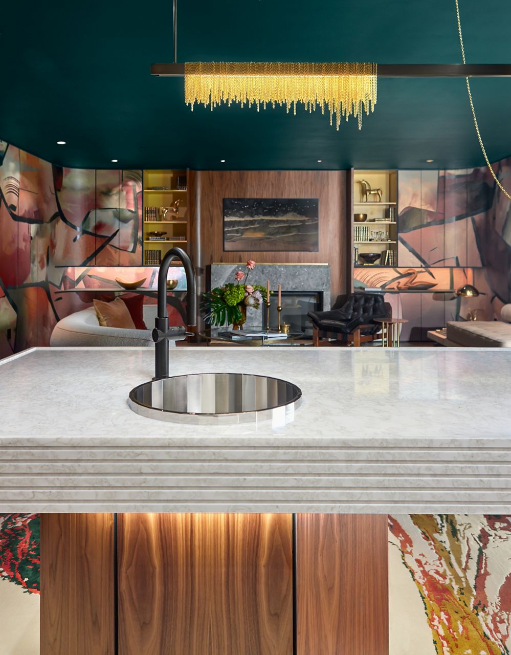 A wet bar island with a matte black faucet and a stainless steel bar sink.