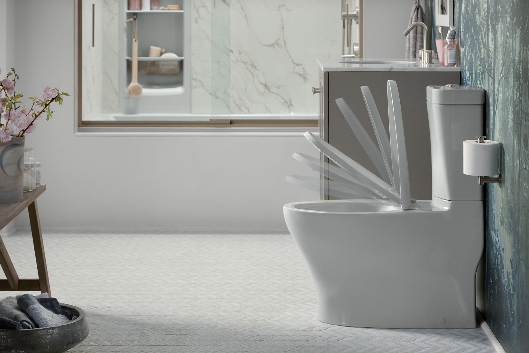 Time-lapse photo of a white bathroom with Reveal Quiet-Close toilet seat closing