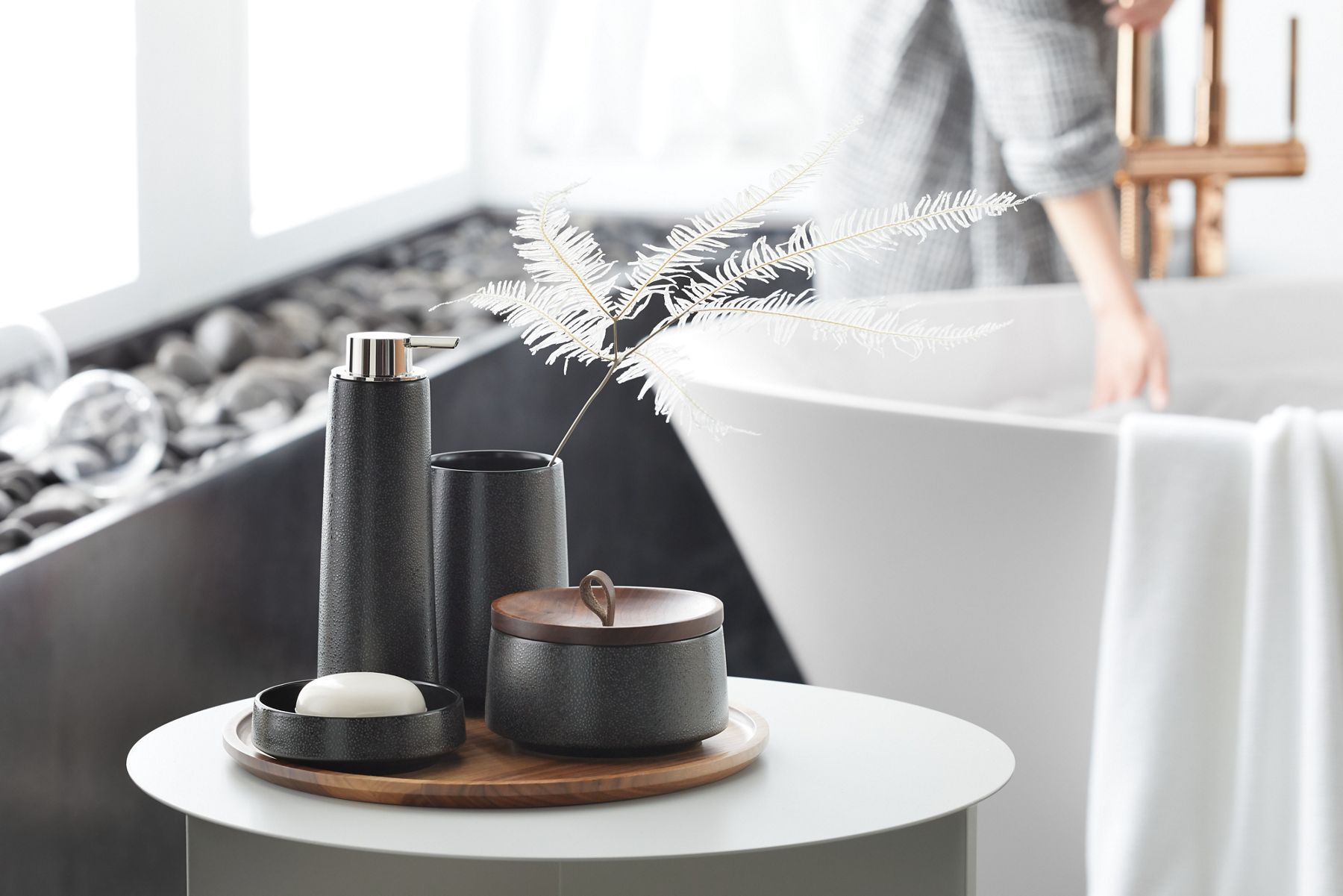 KOHLER Bente ceramic soap dispenser, tumbler, lidded canister, soap dish, and wooden tray in a bathroom