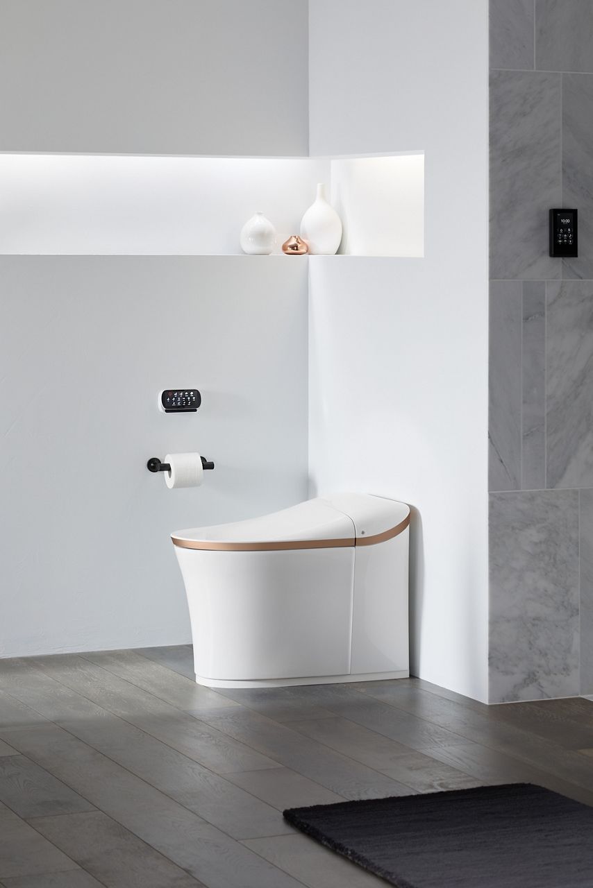 Minimalist bathroom with KOHLER Eir intelligent toilet and freestanding bathtub