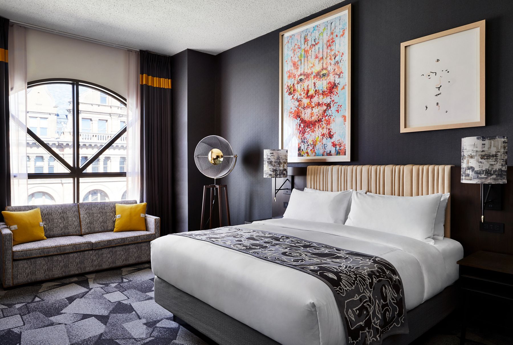 A photo of one of the hotels ecclectic guest suites featuring colorful accents and abstract wall decor.
