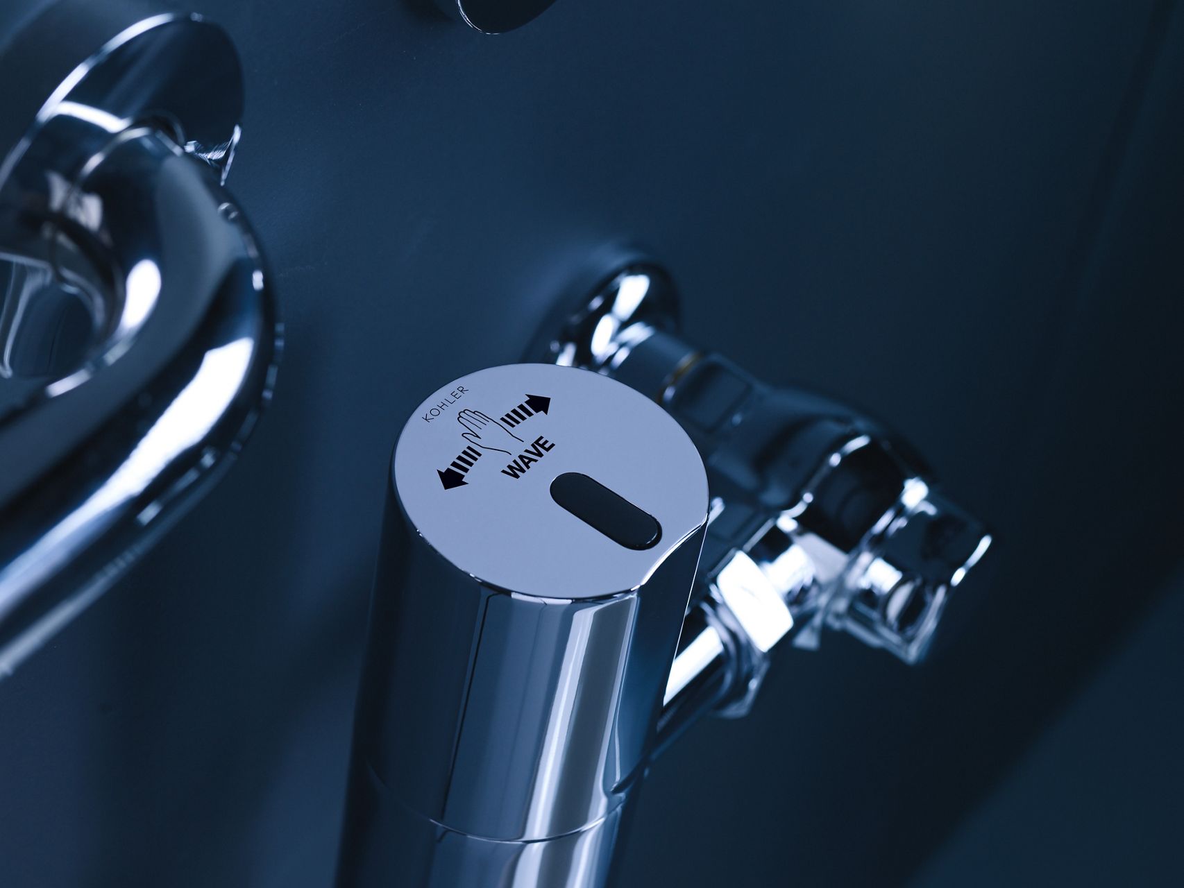 Close up of a Wave Sensor touchless activation flushometer.
