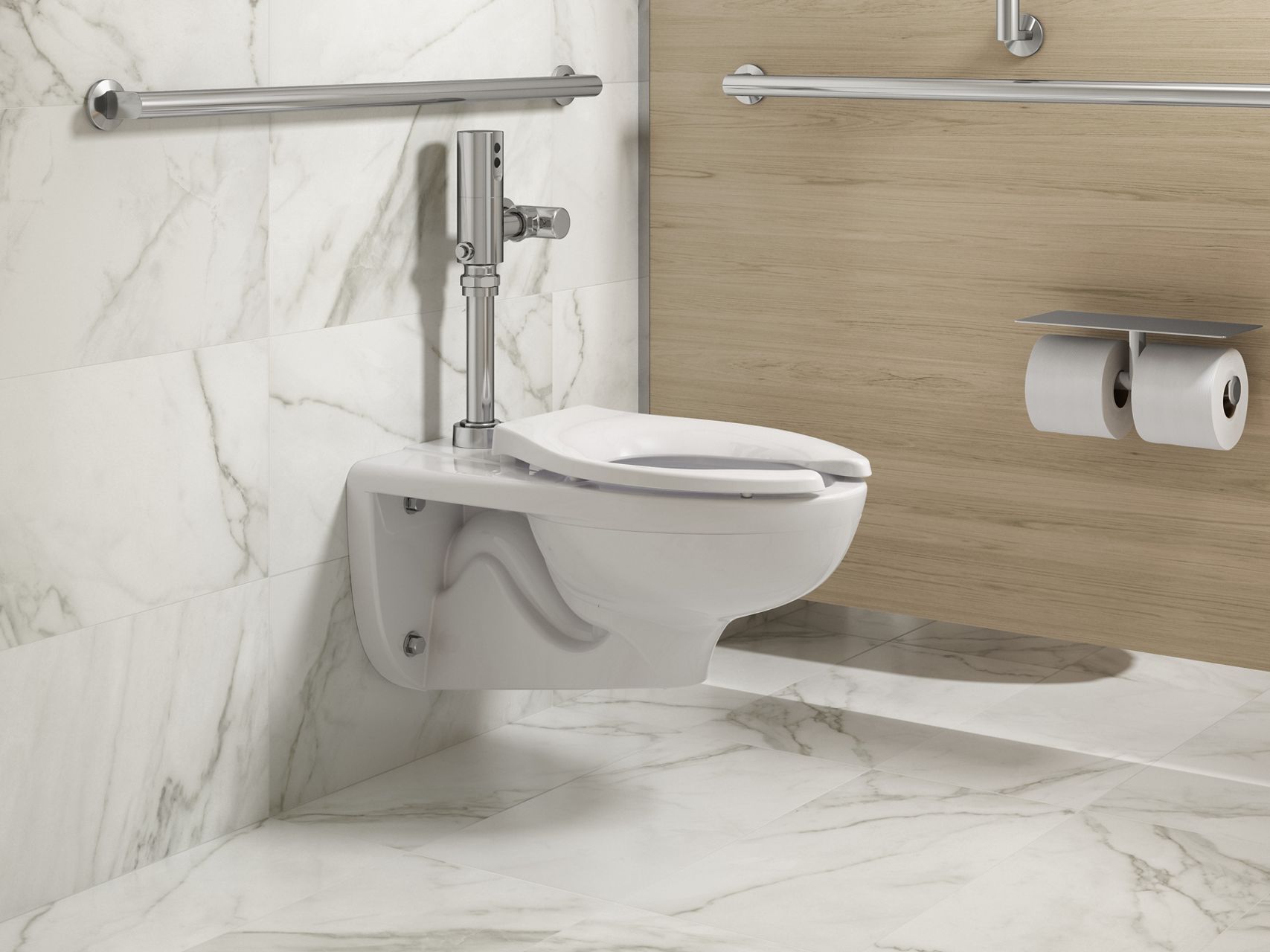 Wall mount toilet with a chrome flushometer against a white and gray marble wall with a wood grain wall as a divider between it and the next stall over.