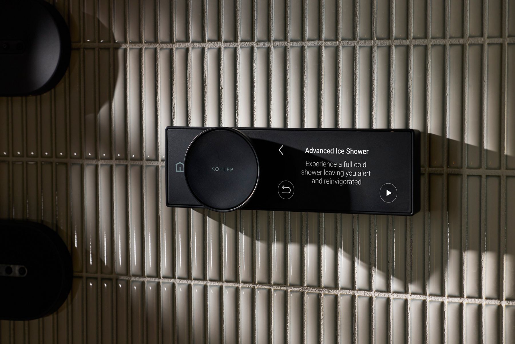 Kohler Advanced Ice Shower control Panel showing curated audio and temperature settings on a tiled background.