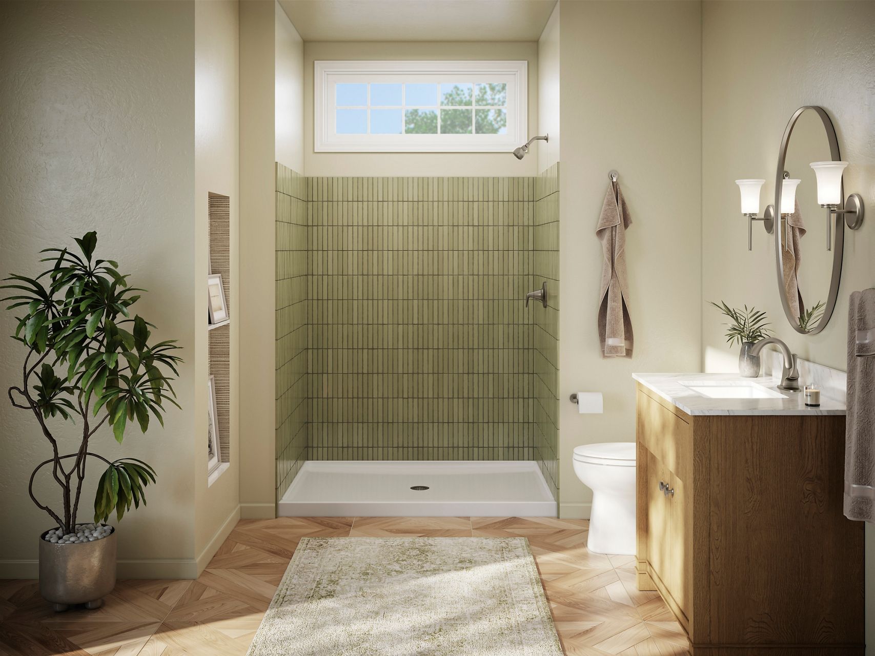 A bright and open bathroom with a green tiled shower, white shower base, wood flooring, and silver accents.