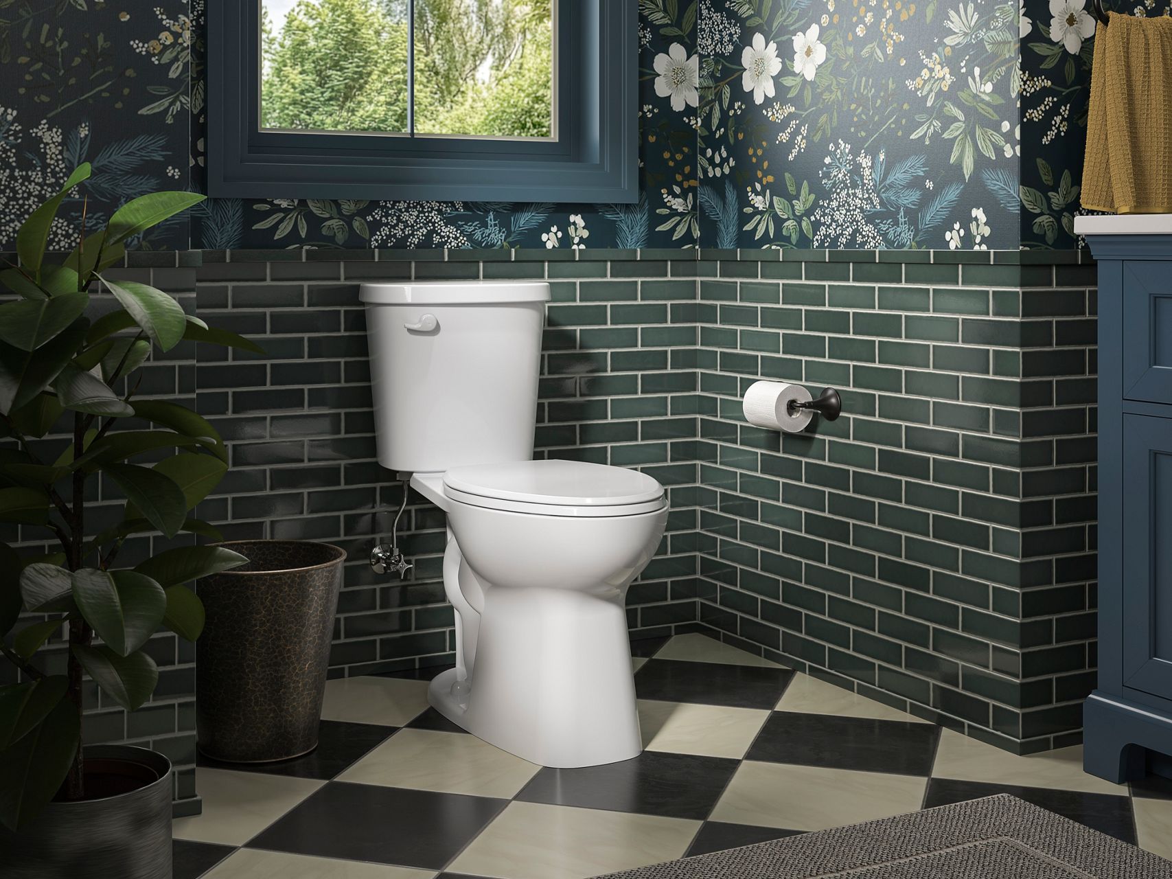 Classic white toilet in a statement bathroom, featuring green subway tile, floral wallpaper, and patterned flooring.