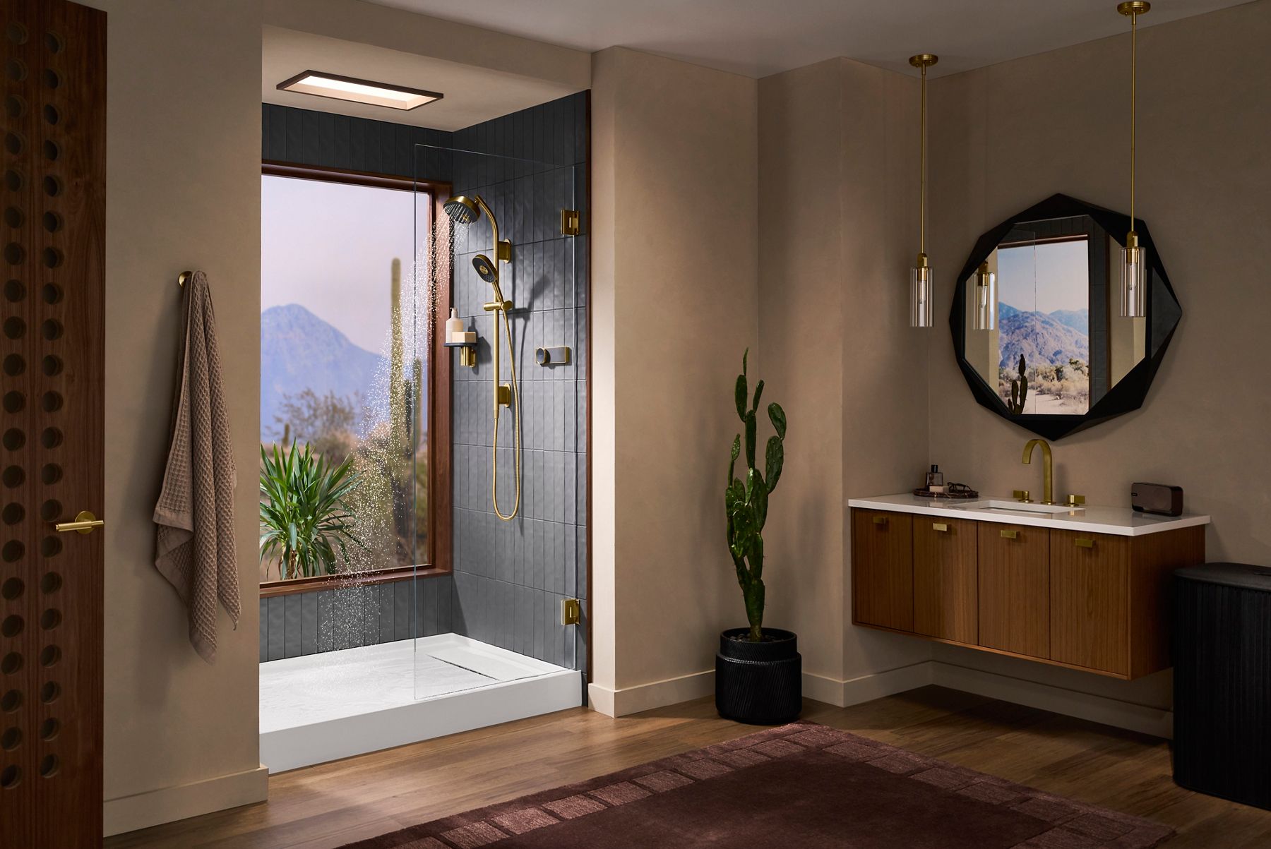 Anthem EvoCycle Shower featured in a bright open bathroom with a desert view, wood flooring, and gold accents.
