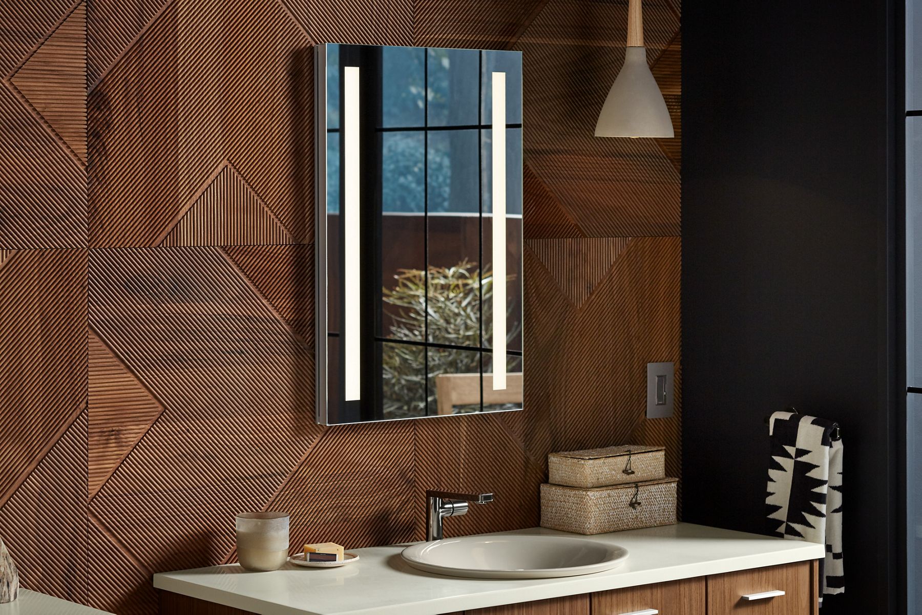 A recessed KOHLER Verdera lighted medicine cabinet is mounted above a vanity with an undermount sink.