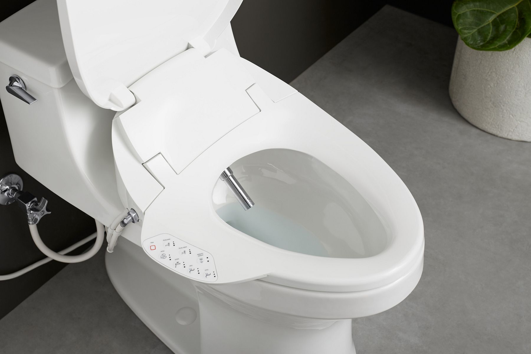 An overhead view of a toilet with a bidet seat with an open lid, showing the bidet cleansing wand and seat-mounted control panel.