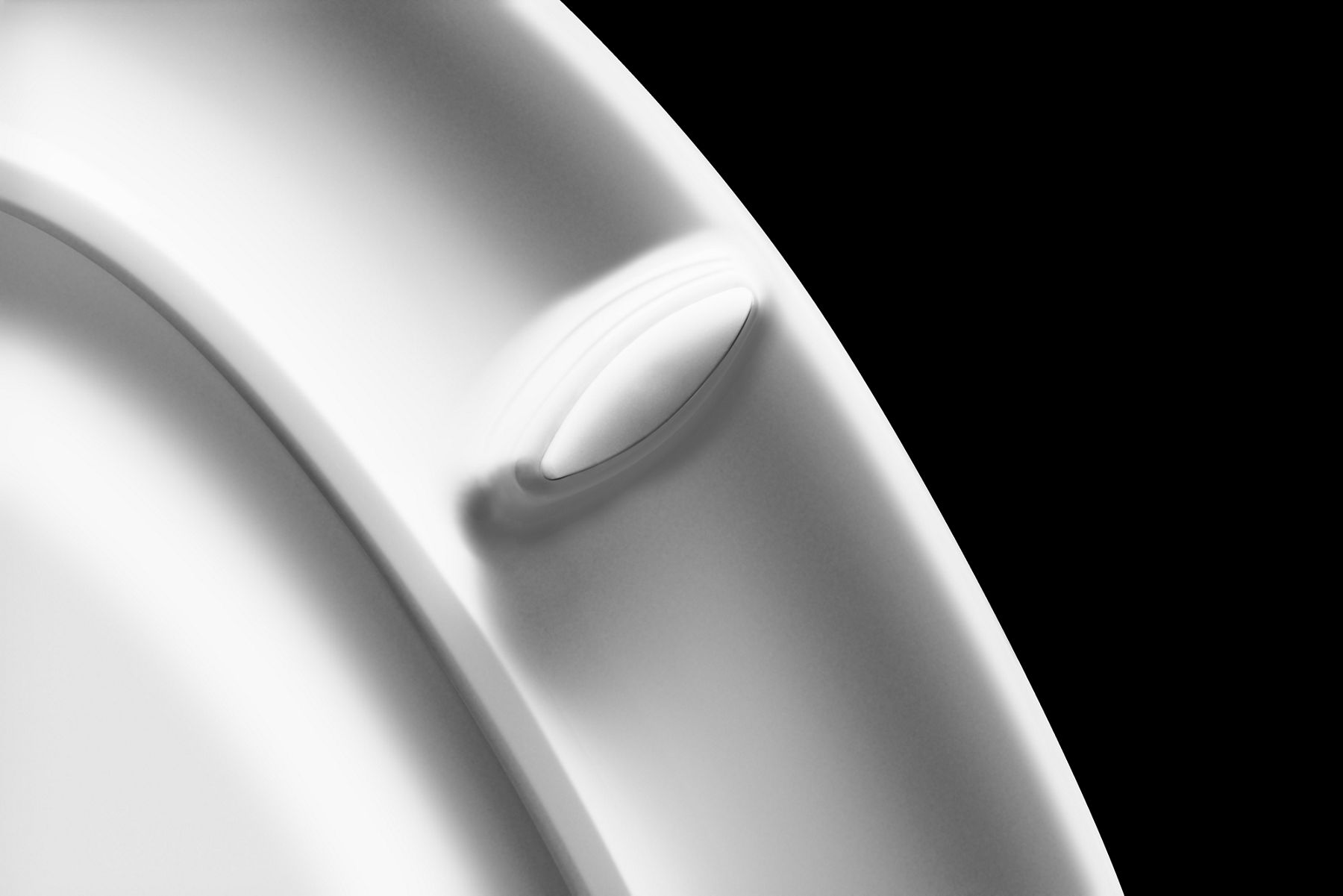 A detail of the underside of a toilet seat with rubber bumpers to keep it securely in place.