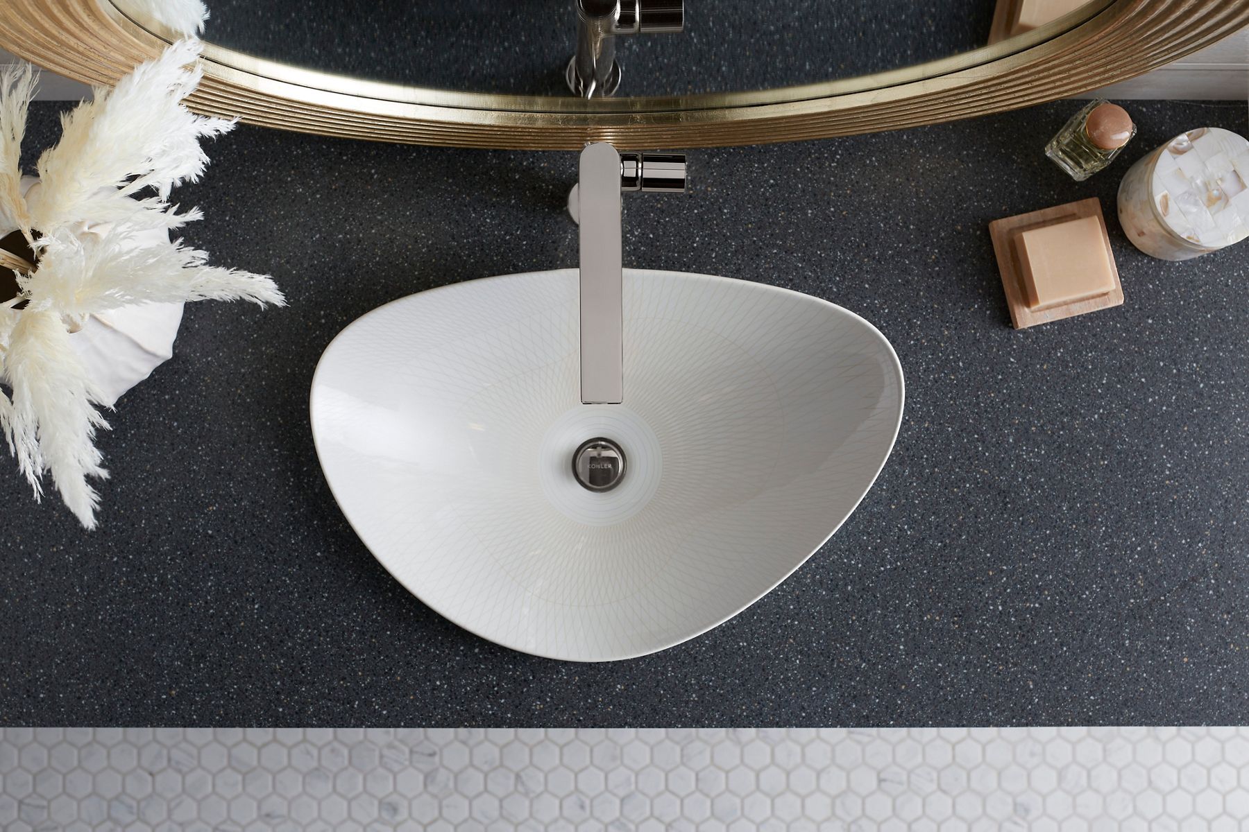 Overhead view of an asymmetrical triangular white vessel bathroom sink.