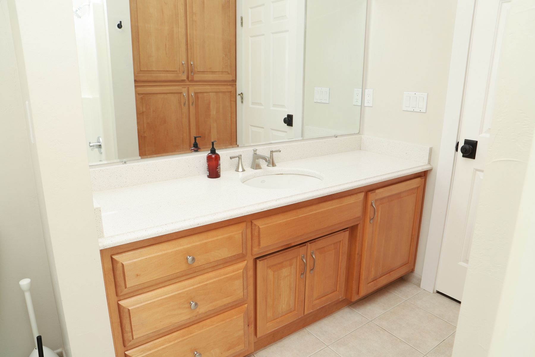 Bathroom with wood cabinet vanity and large mirror
