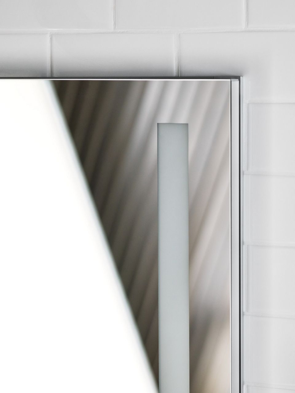 A close-up view of a KOHLER Verdera lighted medicine cabinet with flat edges.
