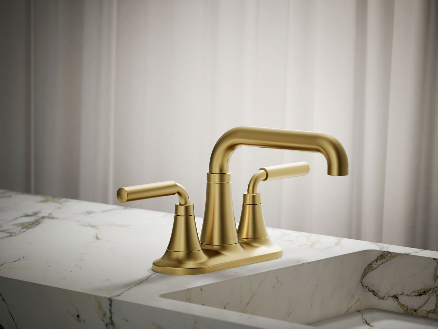 Brushed gold wall-mounted faucet with dual cone-shaped handles and straight spout over marble sink.