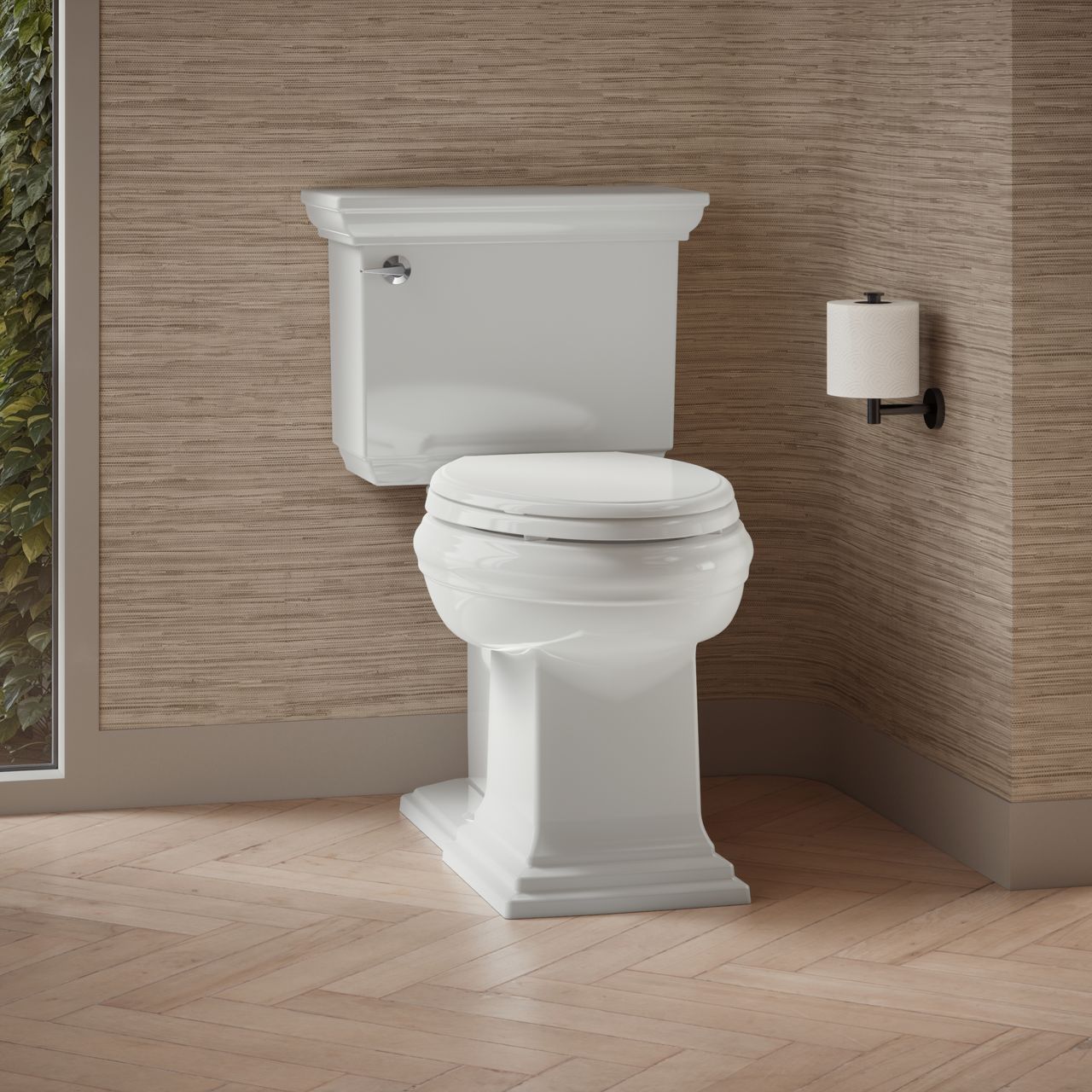 Claude collection white two-piece toilet displayed in a traditional bathroom with textured wall coverings and warm natural light.
