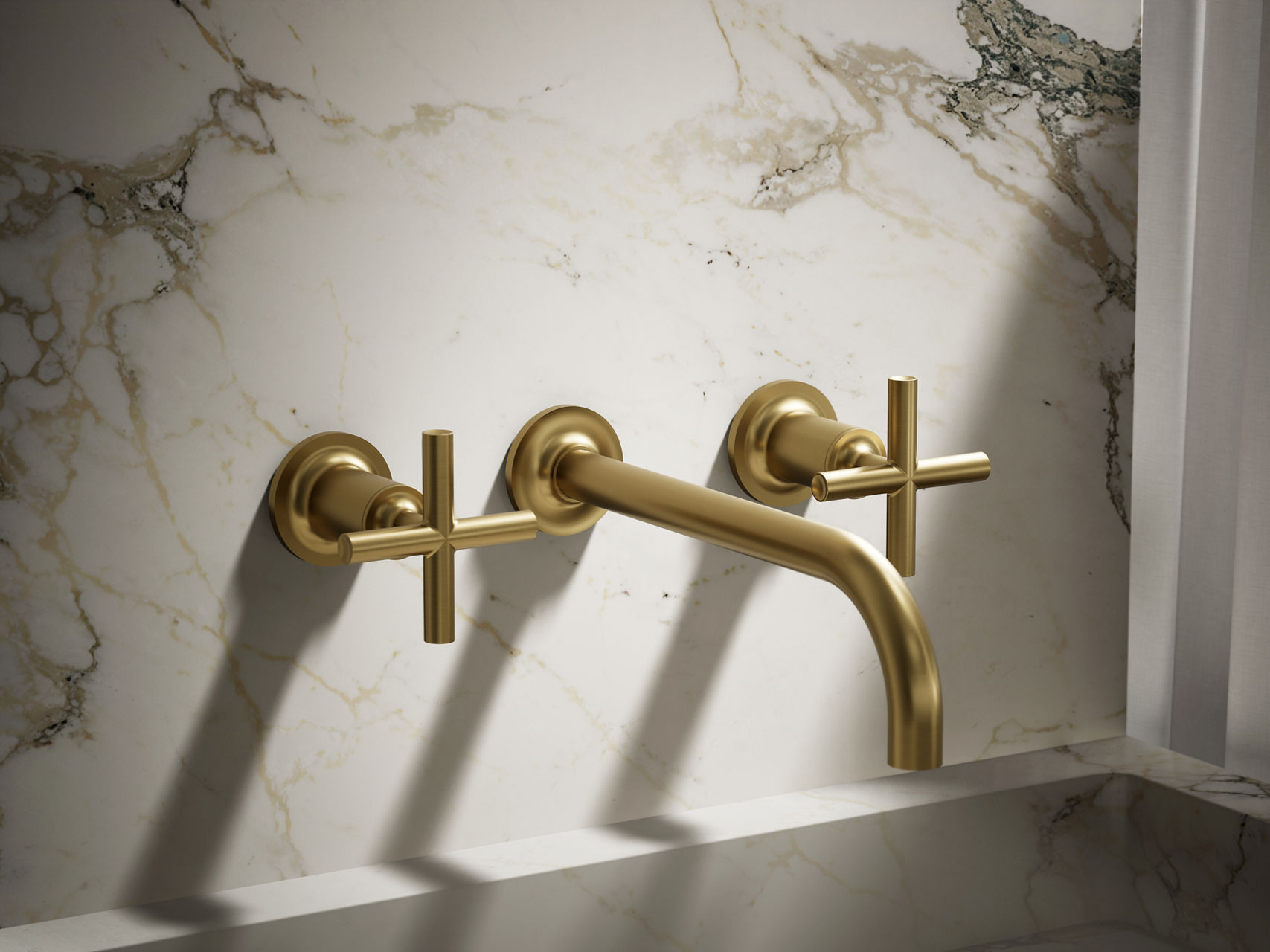 Vintage-style brushed gold three-piece faucet with ornate detailing and classic cross handles.