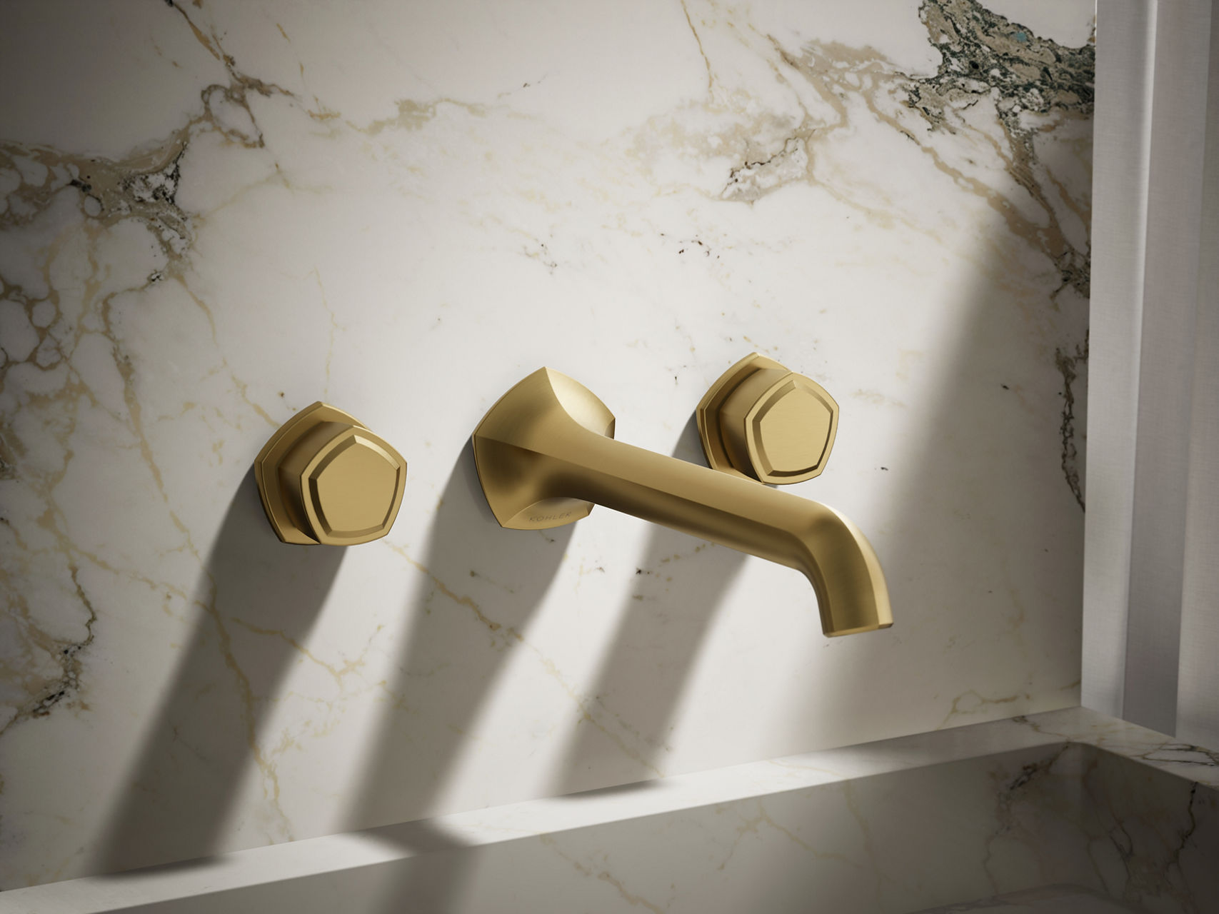Modern brushed gold wall-mounted faucet set with hexagonal handle design and minimalist spout.