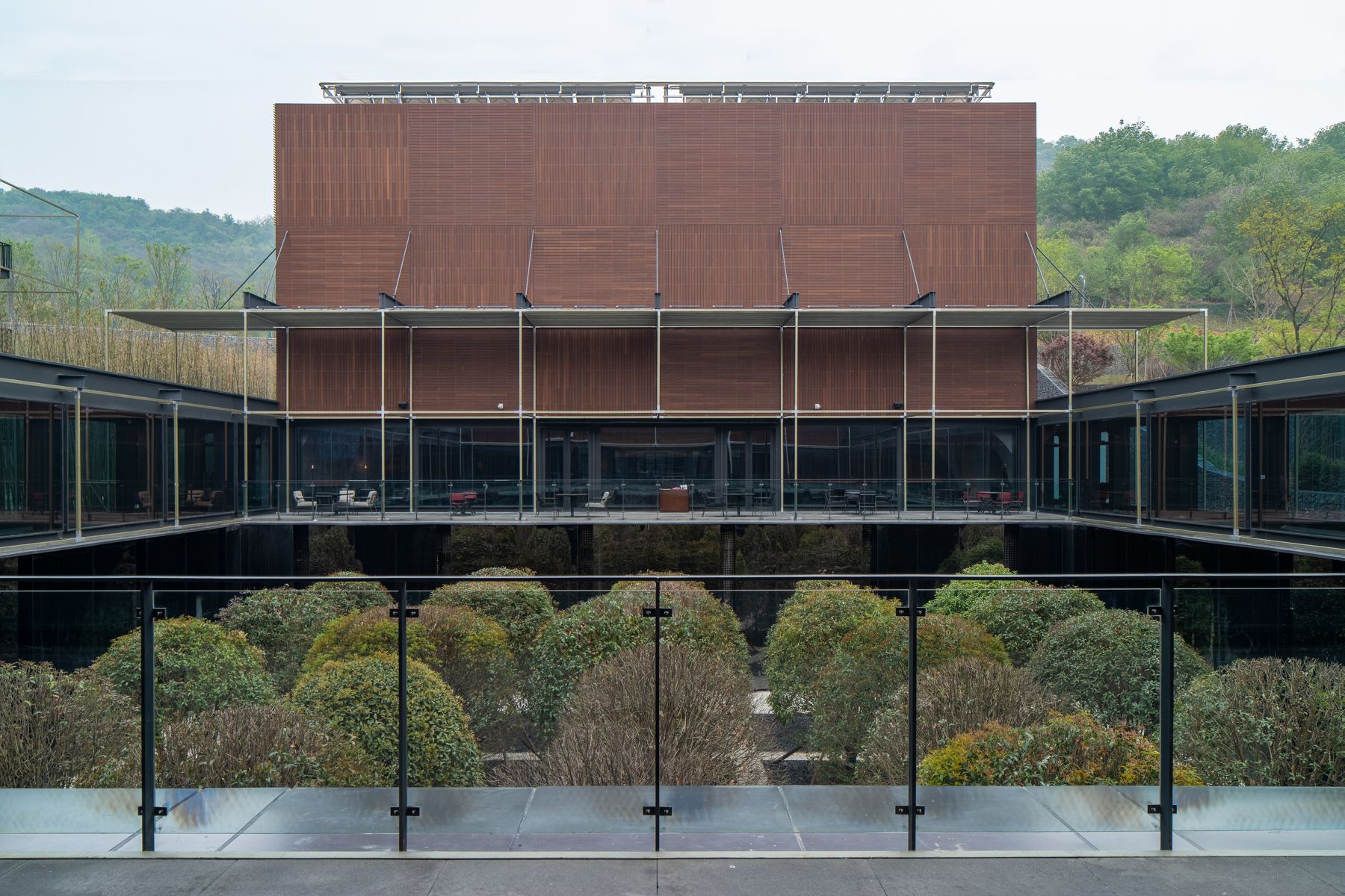 The property's serene design and robust materials build tension between the natural world and bygone industry.