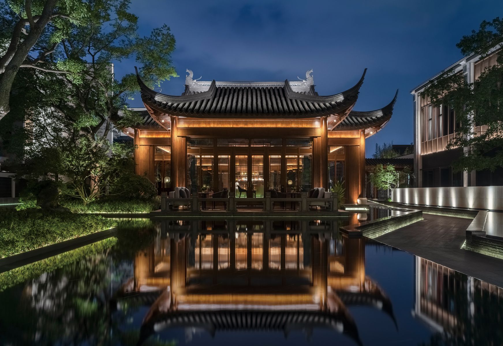 An exterior view of the pavilion-style entrance to the Kimpton Bamboo Grove hotel in Suzhou, China.