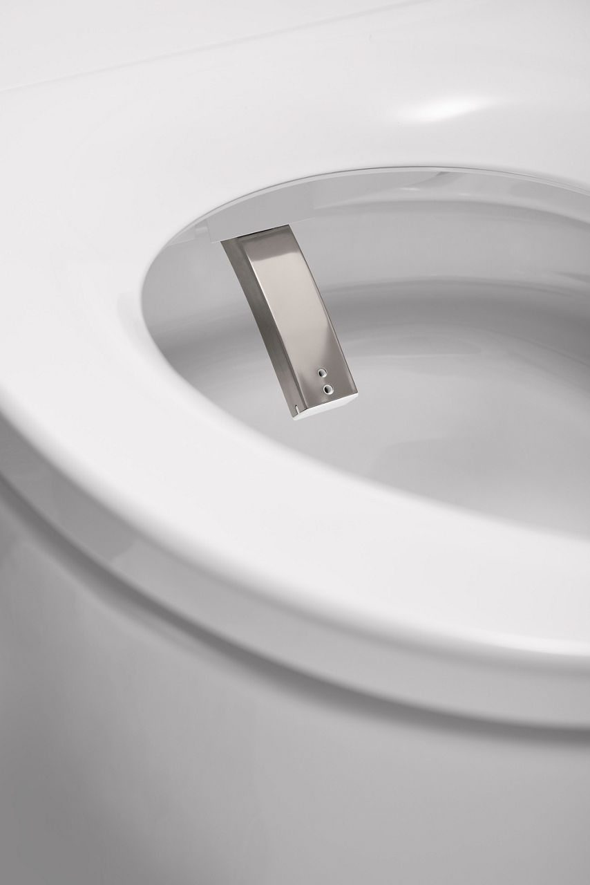 Detail view of a smart toilet with an integrated  bidet inside the bowl.