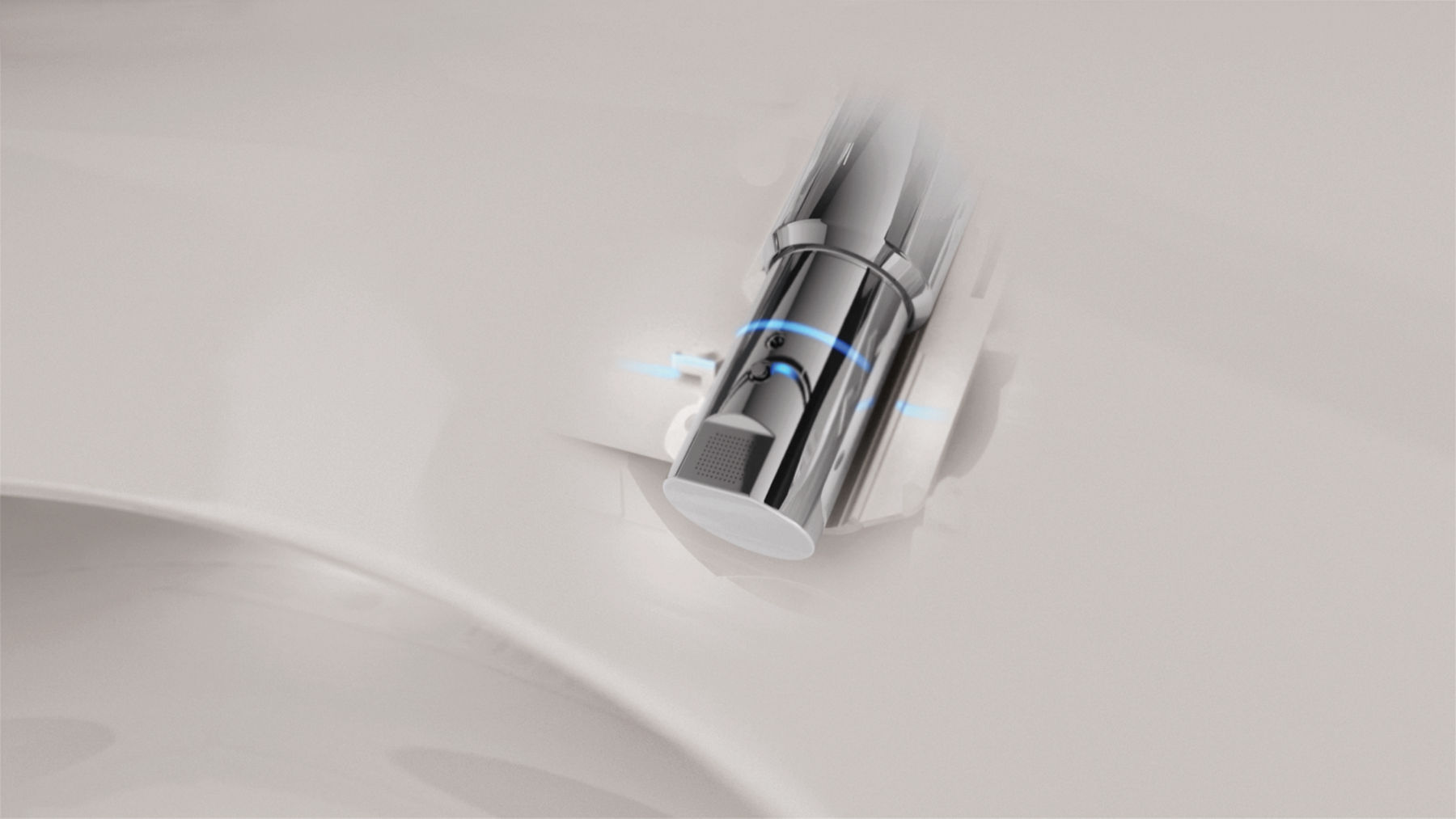 Close-up of a bidet nozzle inside a white toilet bowl.