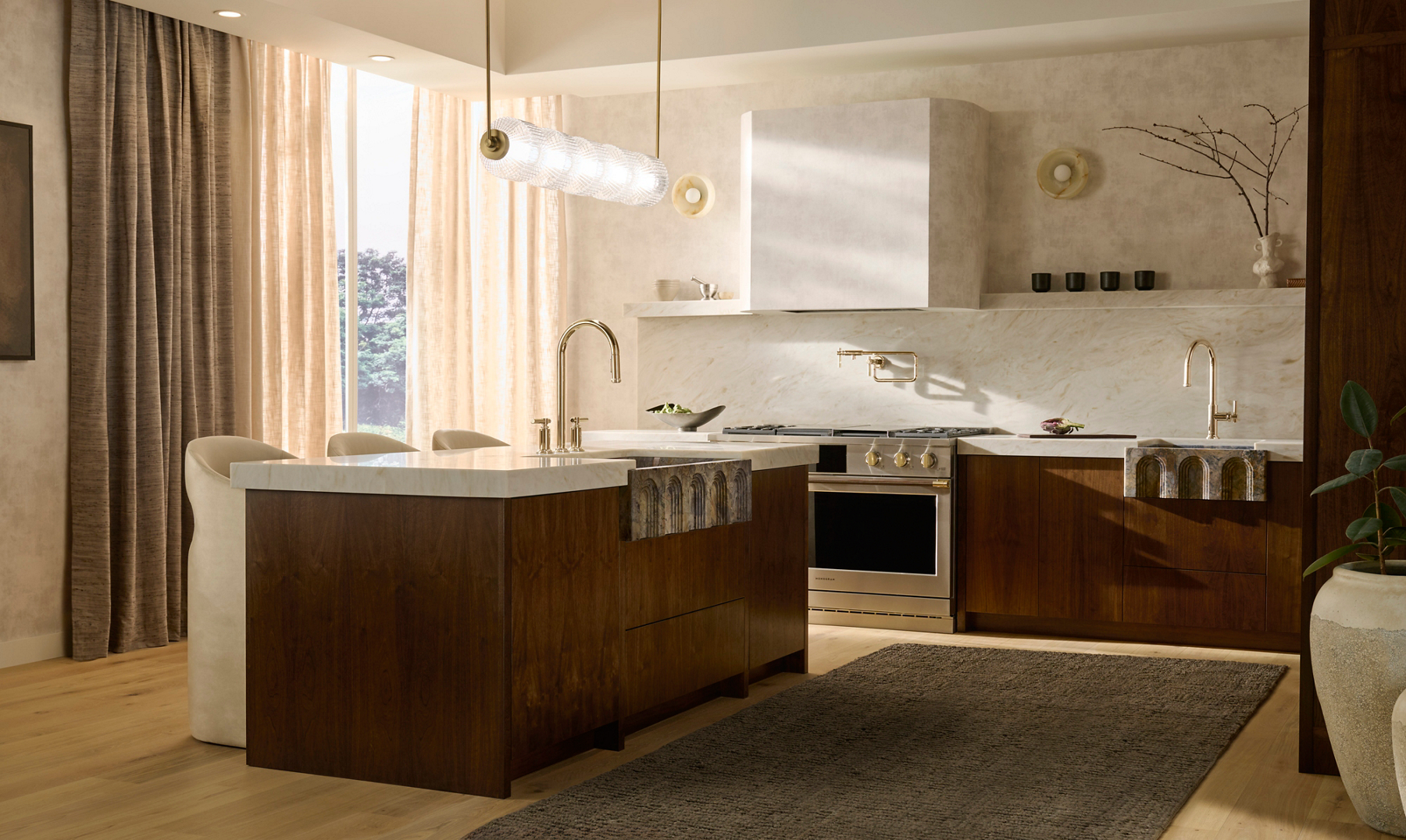 Central Park West kitchen faucet above Voussoir apron-front sink in Fusion Green Quartzite within a walnut-clad kitchen.
