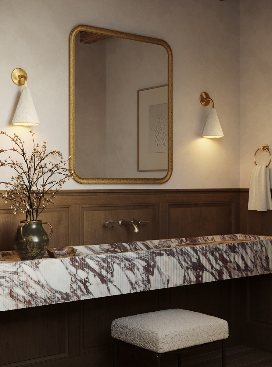 Vir Stil wall-mount sink faucet with lever handles above a fluted Calacatta Viola marble vanity and gilt mirror.
