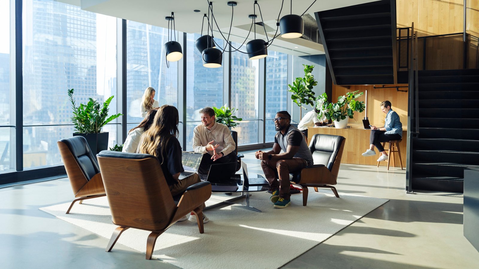 employee lounge area with employees having a team meeting