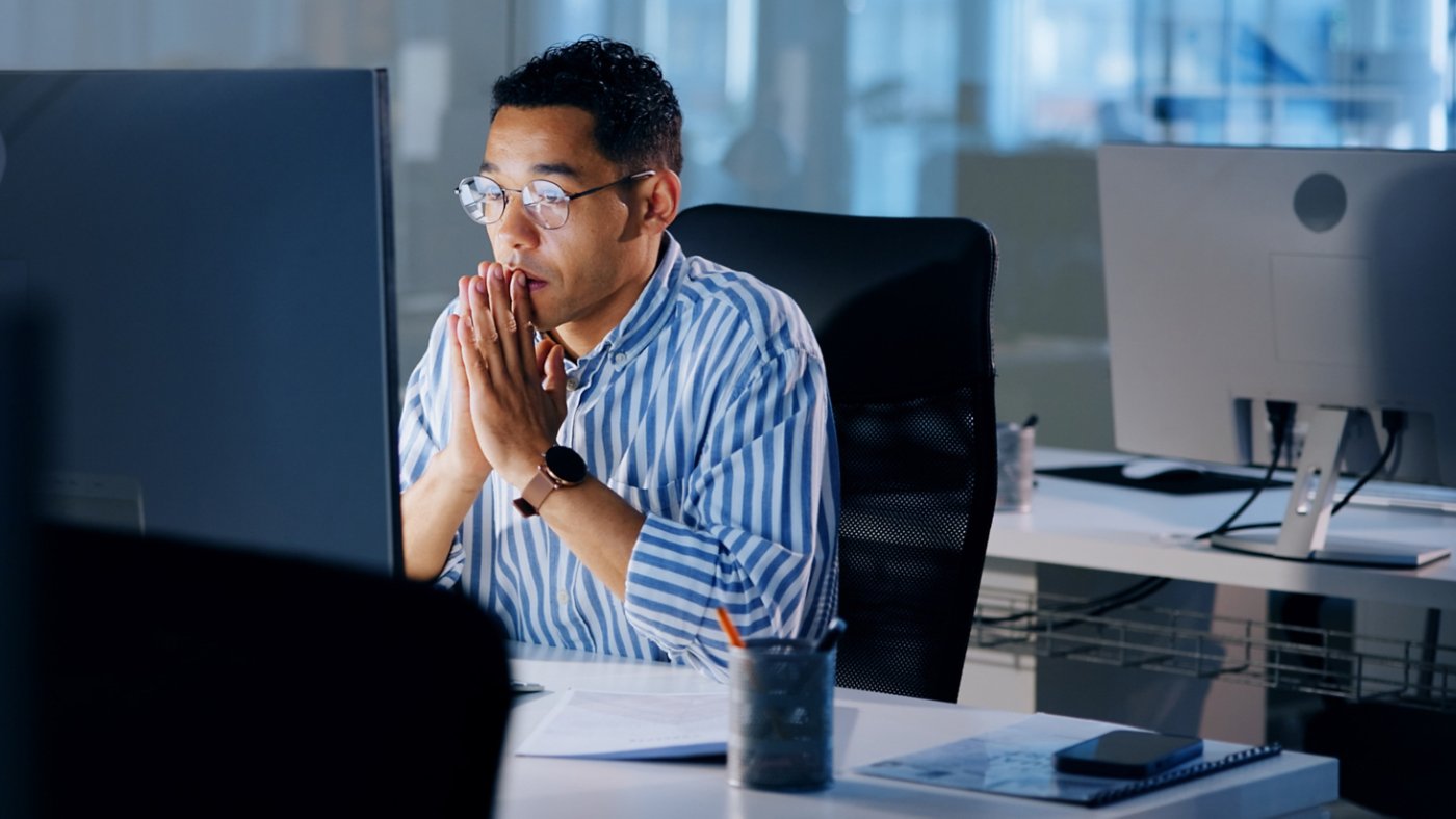 Asian man working on a project on his computer