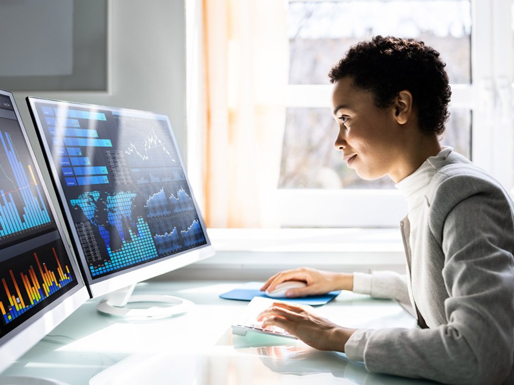 Analyst Women Looking At KPI Data On Computer Screen