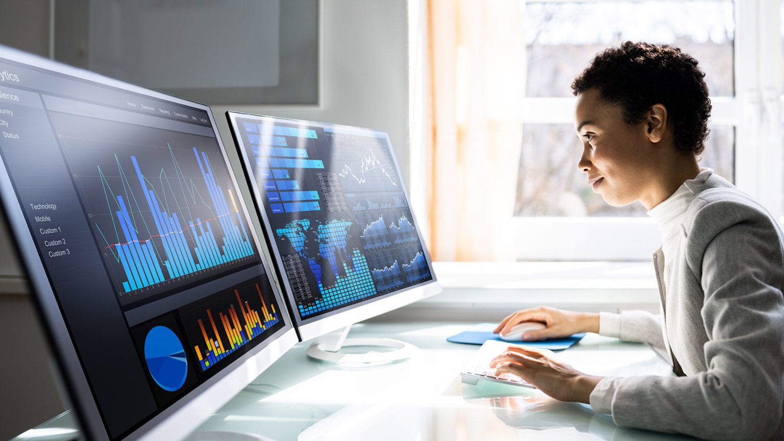 Analyst Women Looking At KPI Data On Computer Screen