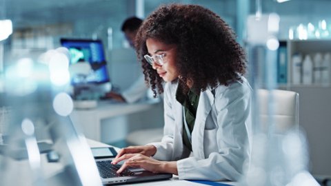 Woman. laptop and lab for research science or online internet for futuristic discovery, microscope or medicine. Female person, brainstorming and biotechnology for investigation, cure or development