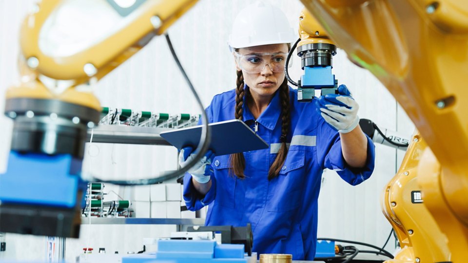 female automation machine engineer student study and inspection control robot arm machine in university or factory workshop. AI robot technology are new innovation trean for manufacturing in industry 5.0