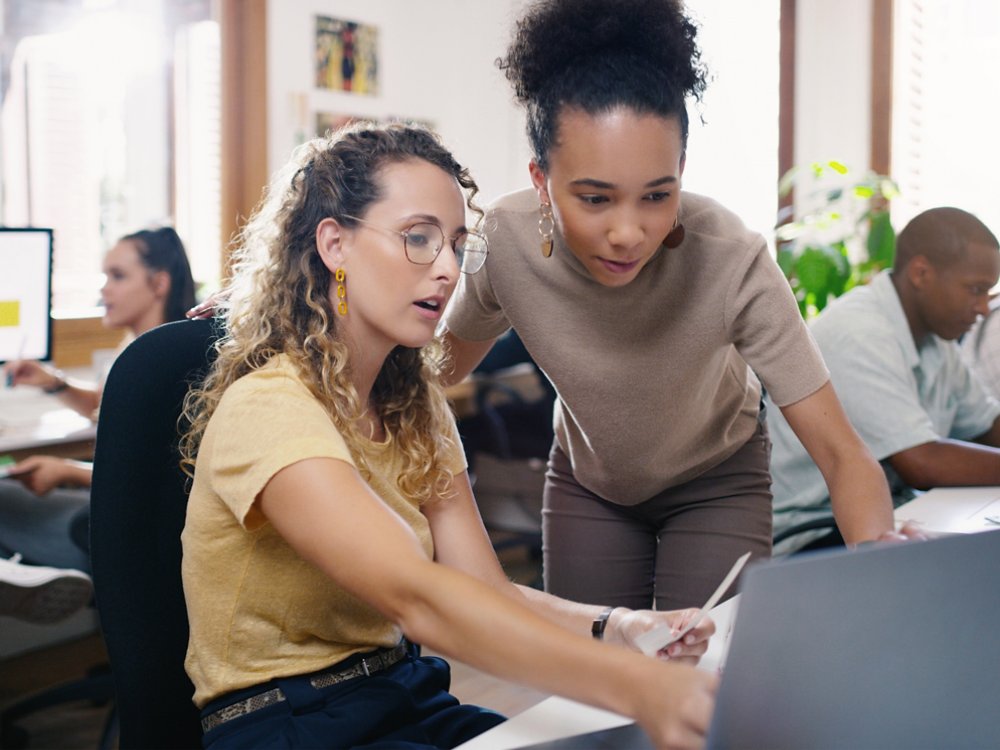 Talking, planning and business people in training with a laptop for leadership and mentoring. Meeting, project management and women speaking about online strategy, ideas or inspiration at work.