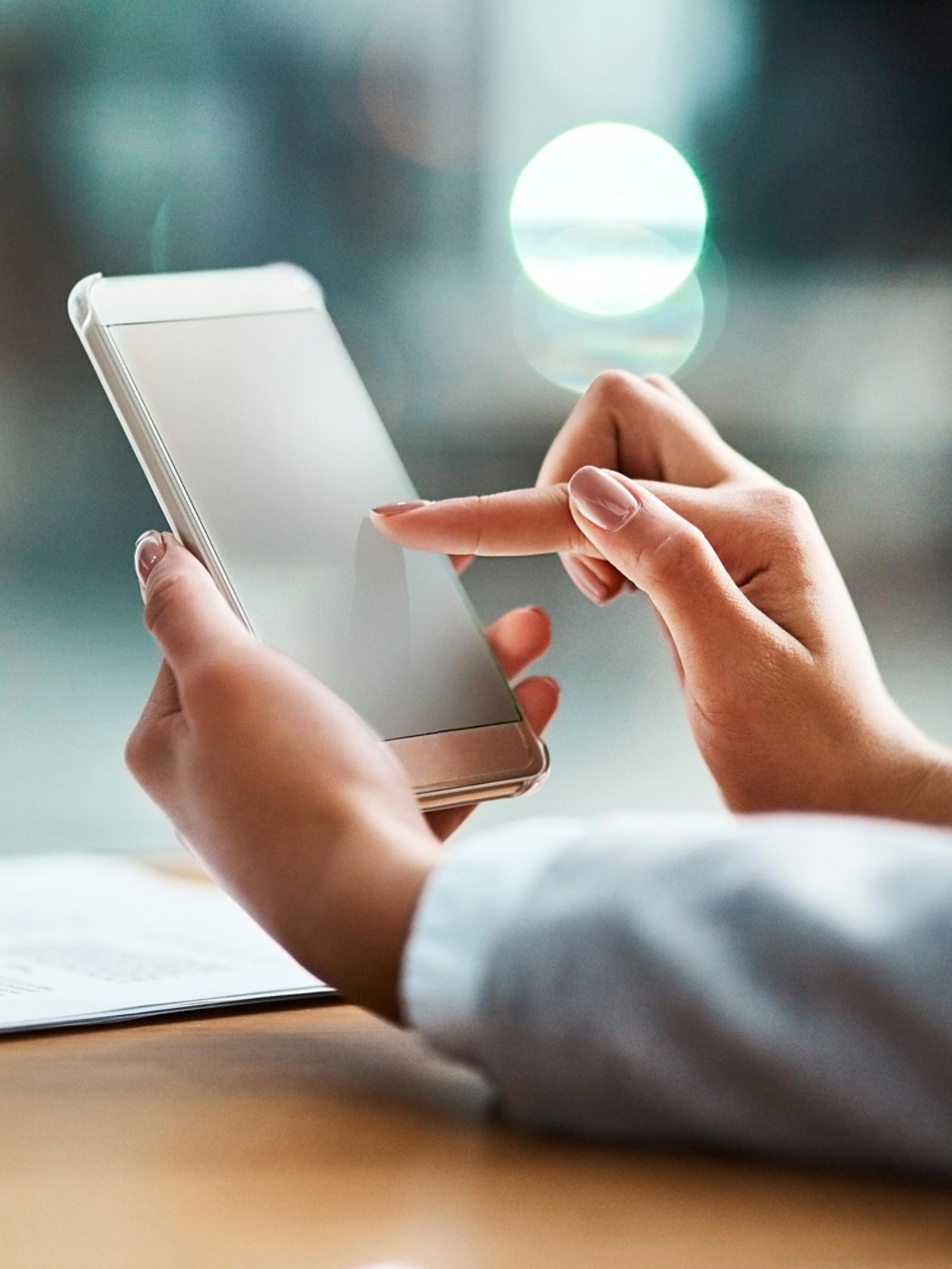 Closeup shot of an unrecognizable businesswoman using a cellphone in an office