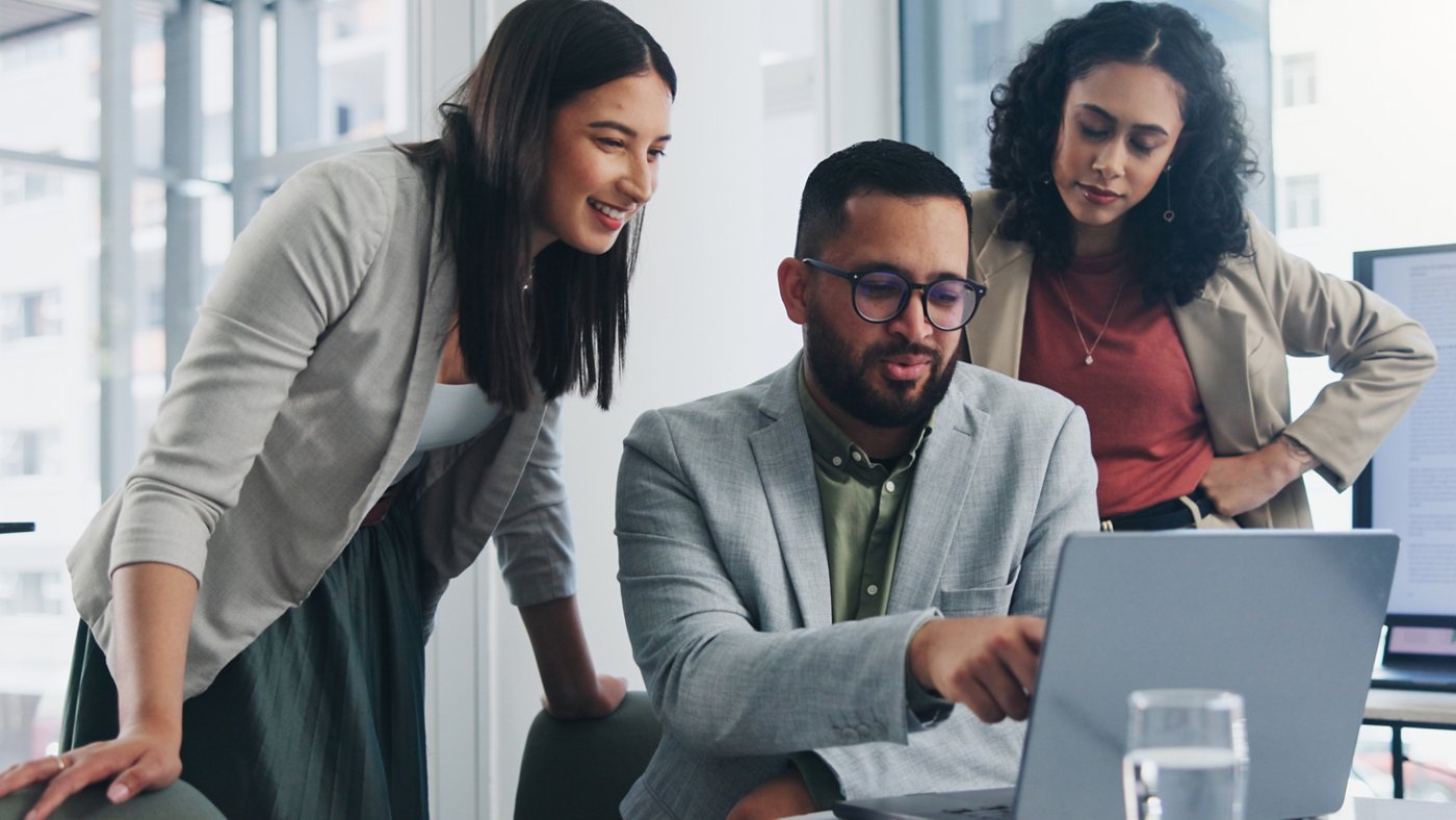 Three people working on a business project - 16x9 version