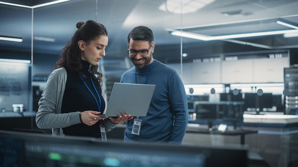 Female and Male Engineers Using Laptop Computer to Analyze and Discuss How to Proceed with the Artificial Intelligence Software. 