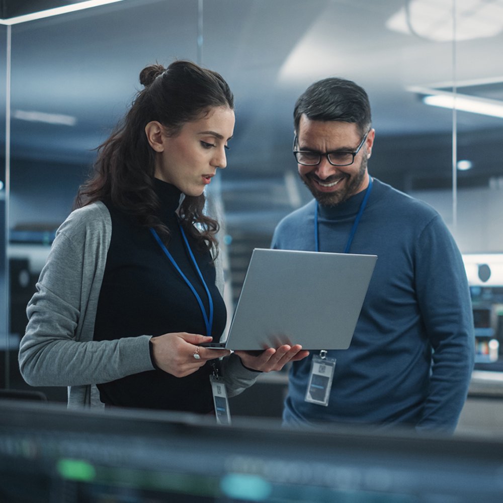 Female and Male Engineers Using Laptop Computer to Analyze and Discuss How to Proceed with the Artificial Intelligence Software. 